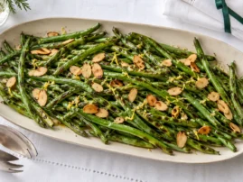 Grilled green beans with toasted sliced almonds, lemon zest, and garlic butter.