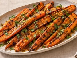 Grilled carrots coated in coffee-chile butter with lime and cilantro.