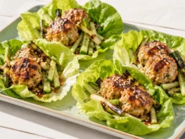 Grilled chicken meatball lettuce cups with cucumber and charred scallions.