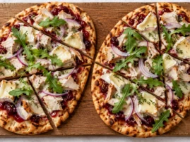 Grilled flatbread wedges topped with turkey, cranberry sauce, melted Brie and arugula.