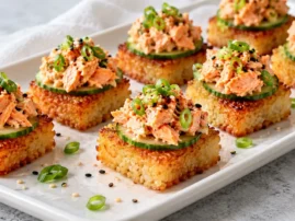 Crispy rice squares topped with cucumber, spicy cooked salmon, scallions, and sesame seeds.