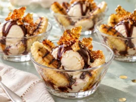 Grilled banana sundaes with vanilla ice cream, chocolate sauce, and sesame crunch.