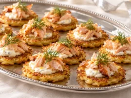 Potato blini topped with hot-smoked trout, lemon creme fraiche, and dill.