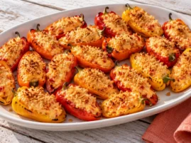 Grilled mini peppers filled with pimento cheese and toasted breadcrumbs.
