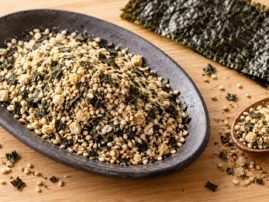 Sesame nori seafood rub on a dark plate with a sheet of nori