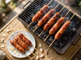 Taiwanese-style grilled sausage skewers, xiang chang, with raw garlic slices.