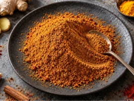 Tandoori-inspired dry rub on a dark plate with ginger, turmeric, coriander and cumin